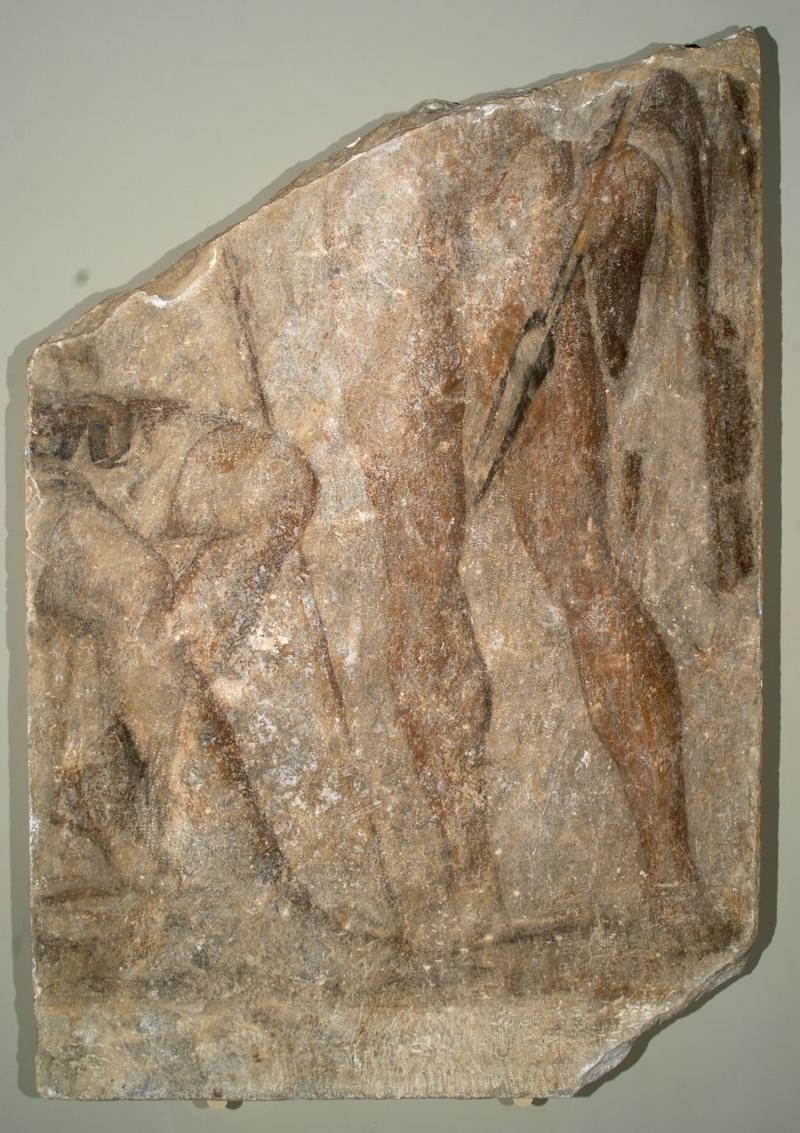 bottom of stele showing warriors legs