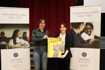 hebe and lucy hold a poster created by classics enthused year 7s  photo provided by oxford high school